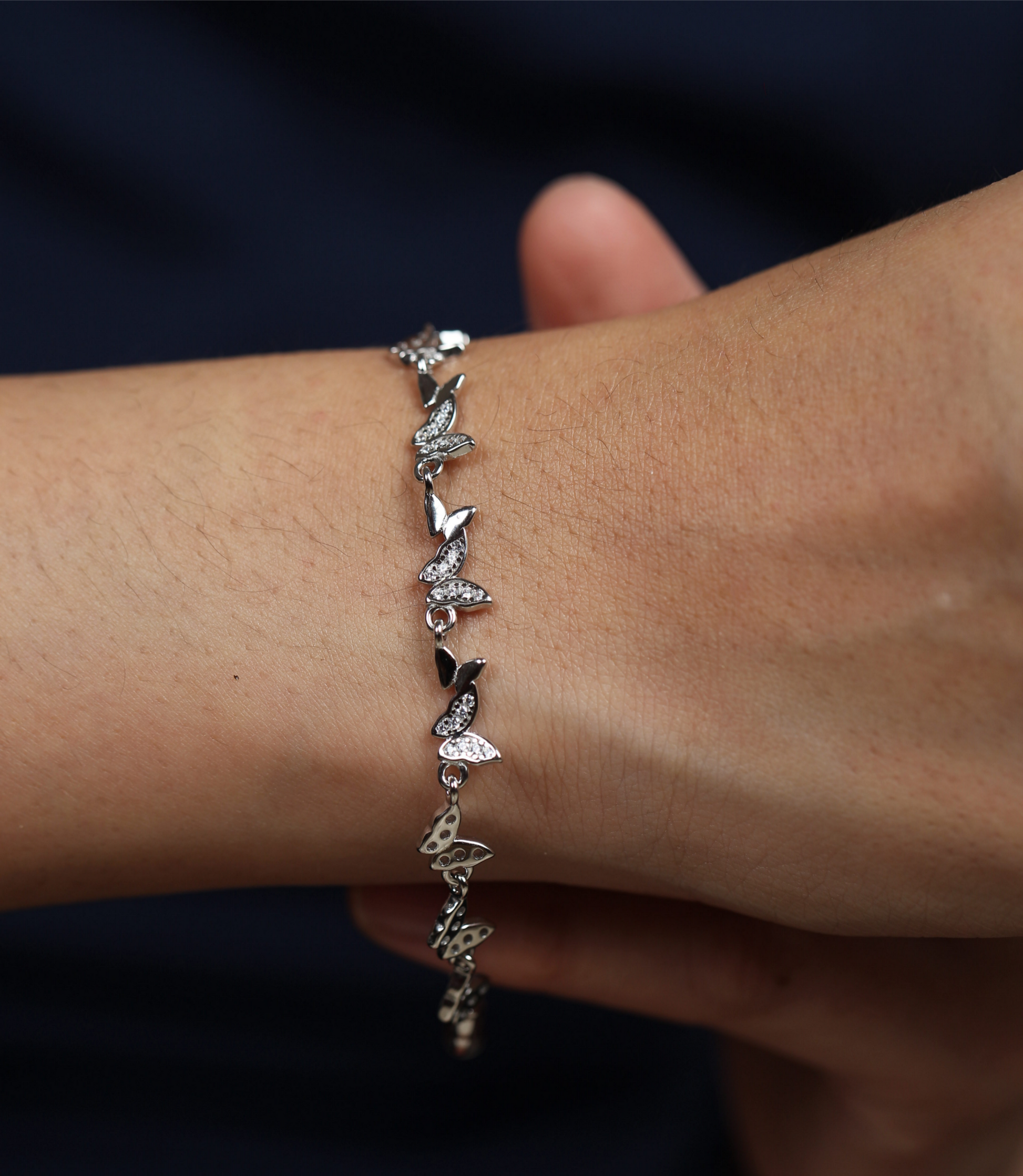 925 silver butterfly bracelet worn on wrist with detailed butterfly charm elements