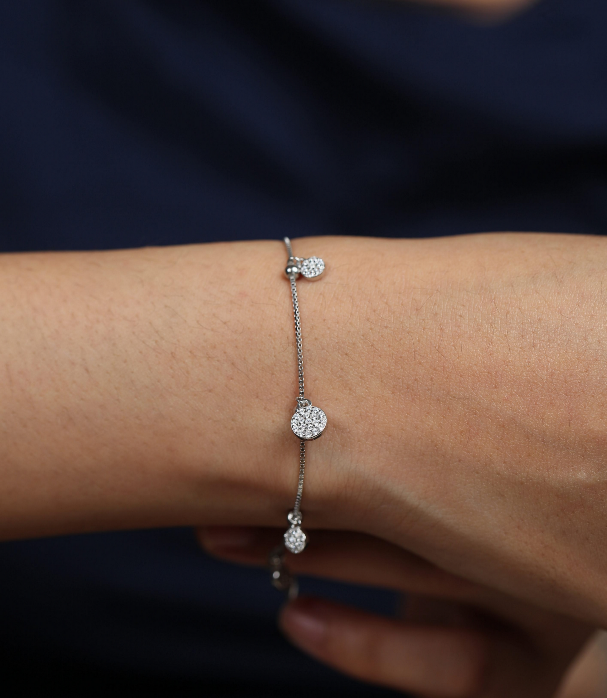 925 silver bracelet with dangling charms worn by woman