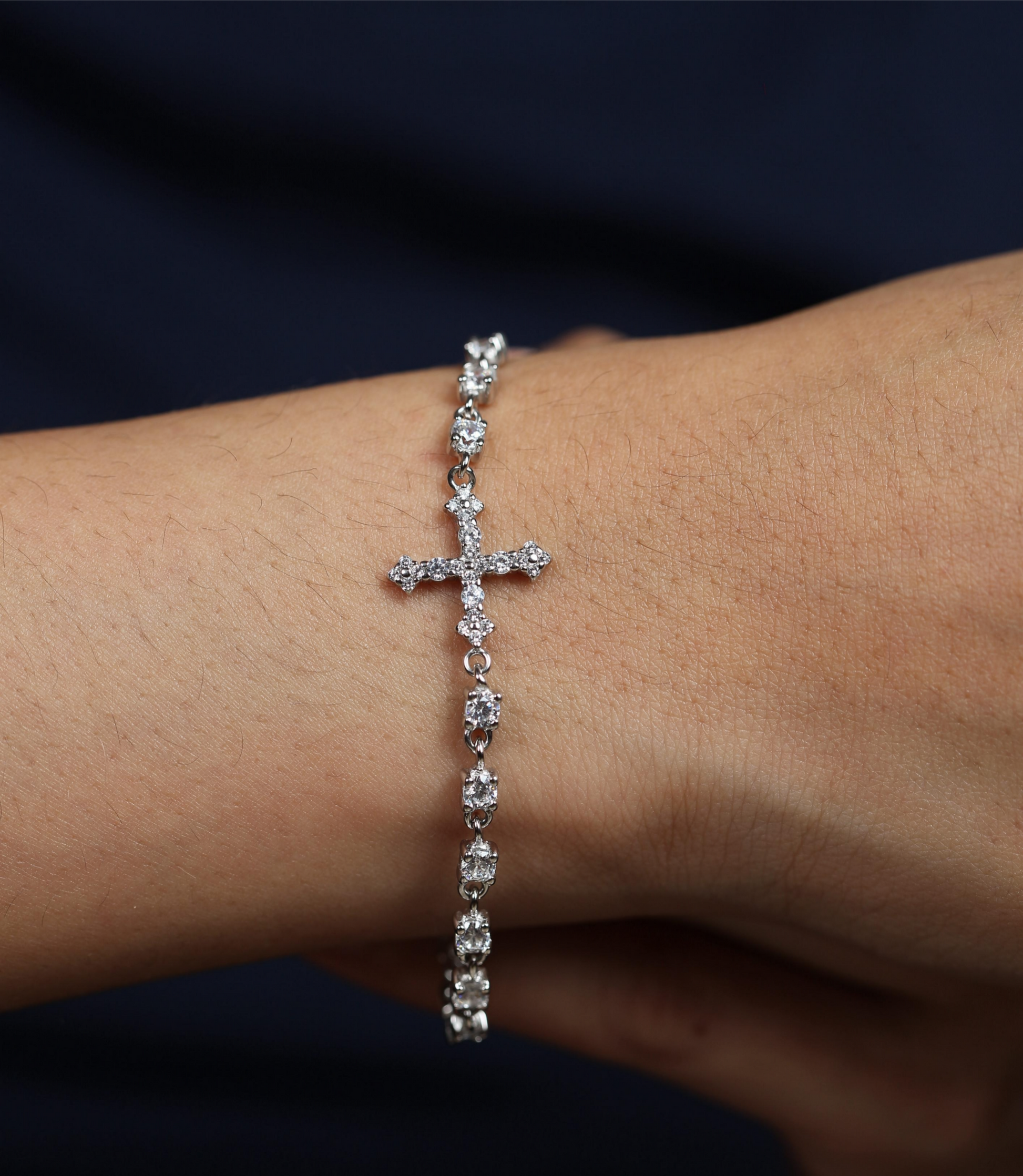 925 silver cross tennis bracelet worn on wrist, showcasing the fine stone arrangement