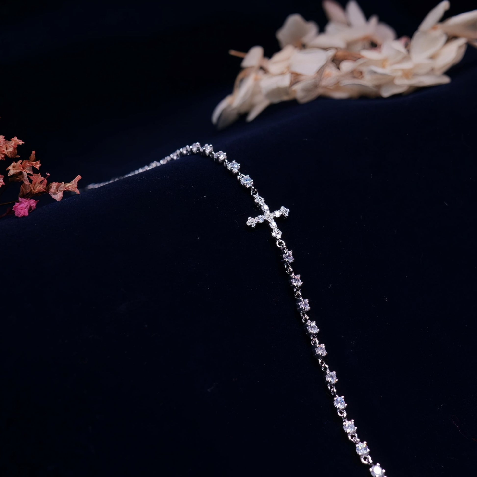 925 silver bracelet with a cross charm and stone detailing, crafted in a tennis style