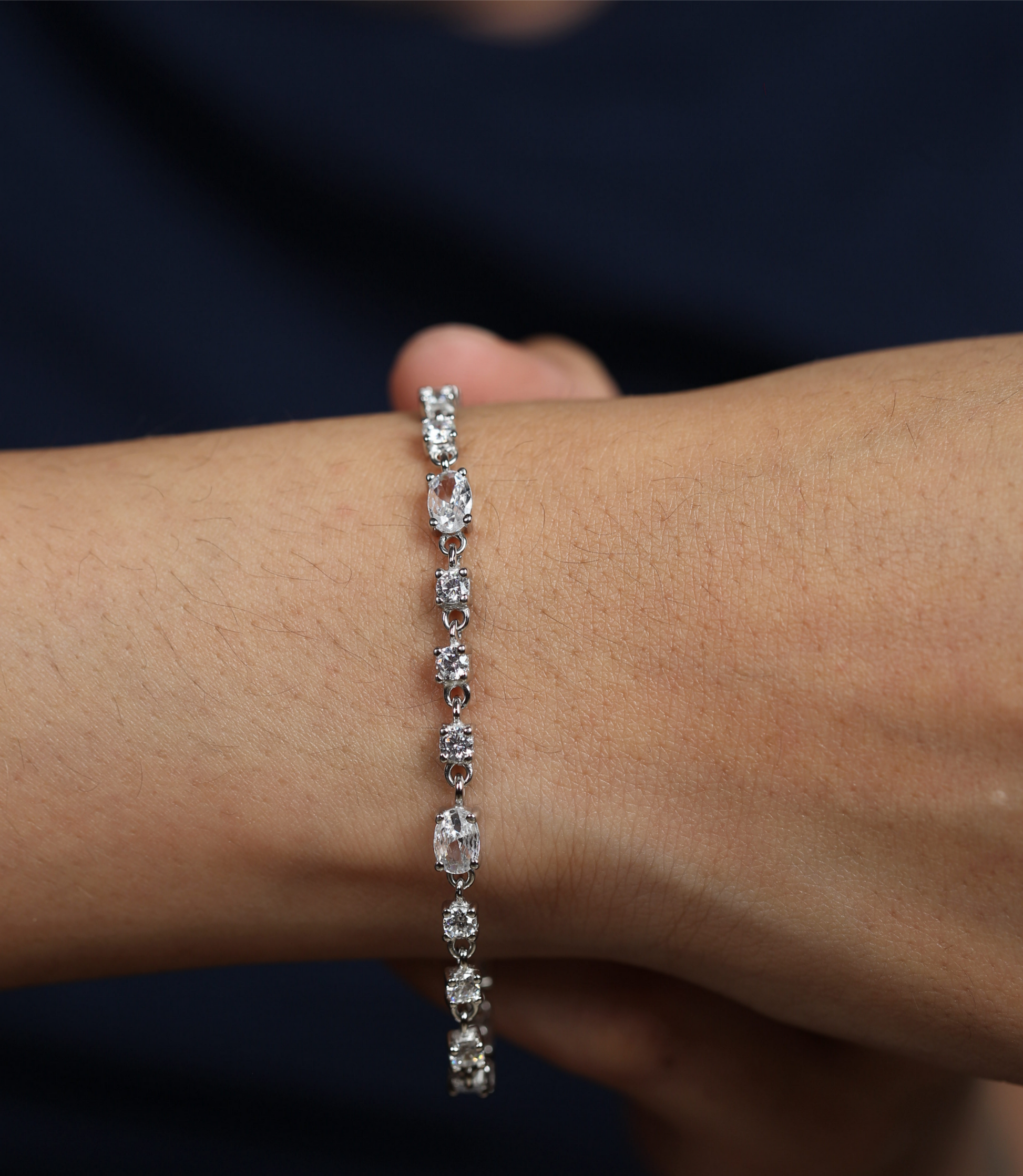 925 silver bracelet worn on wrist with alternating oval and round cut stones